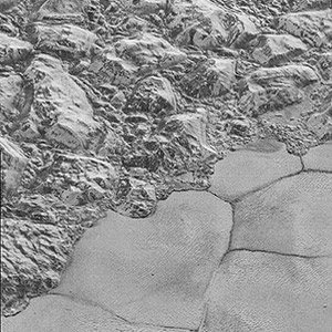 Mountains of ice along a 
                portion of smoother ice planes on Pluto's surface.
